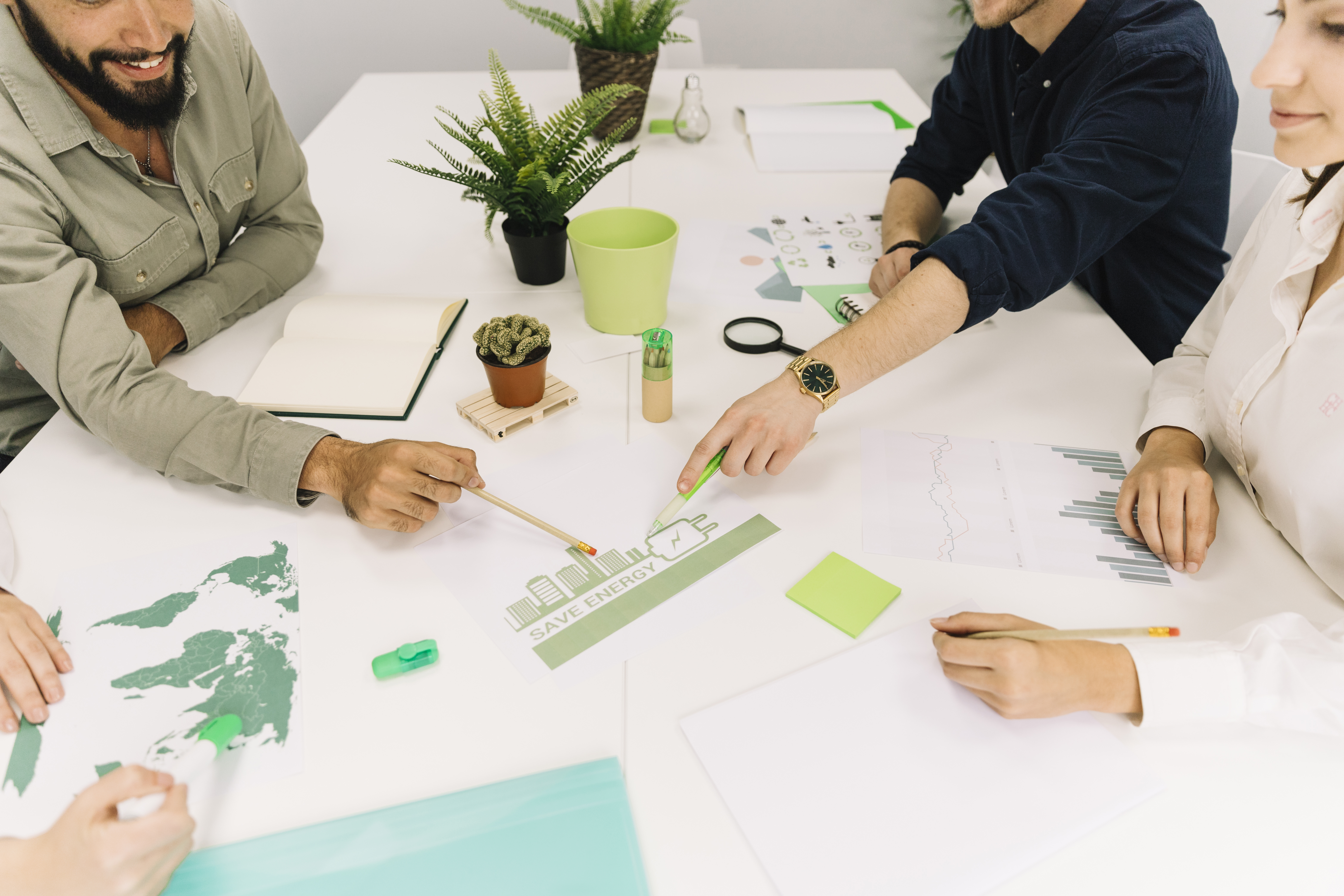 group-of-businesspeople-making-plans-on-energy-saving-at-workplace